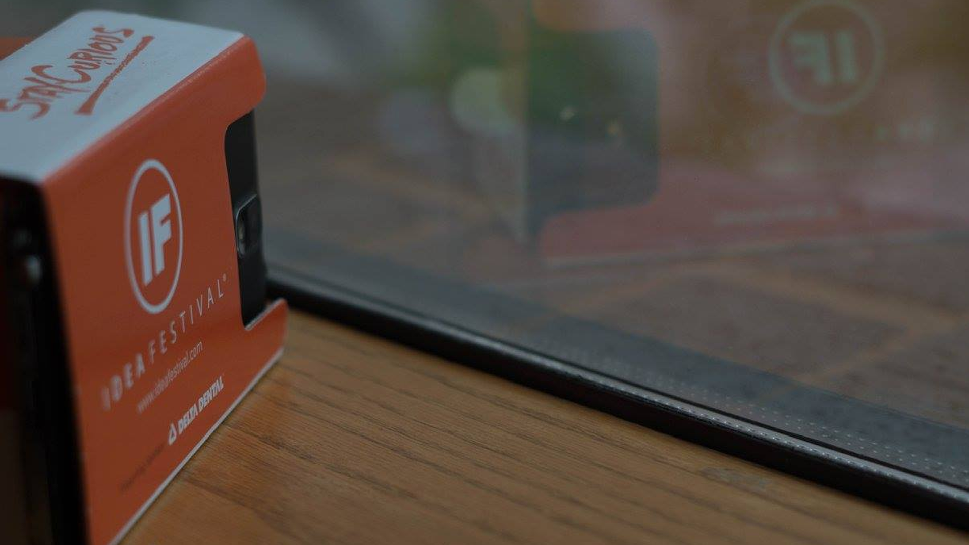 On a wooden windowsill sits an IF Play branded Google Cardboard