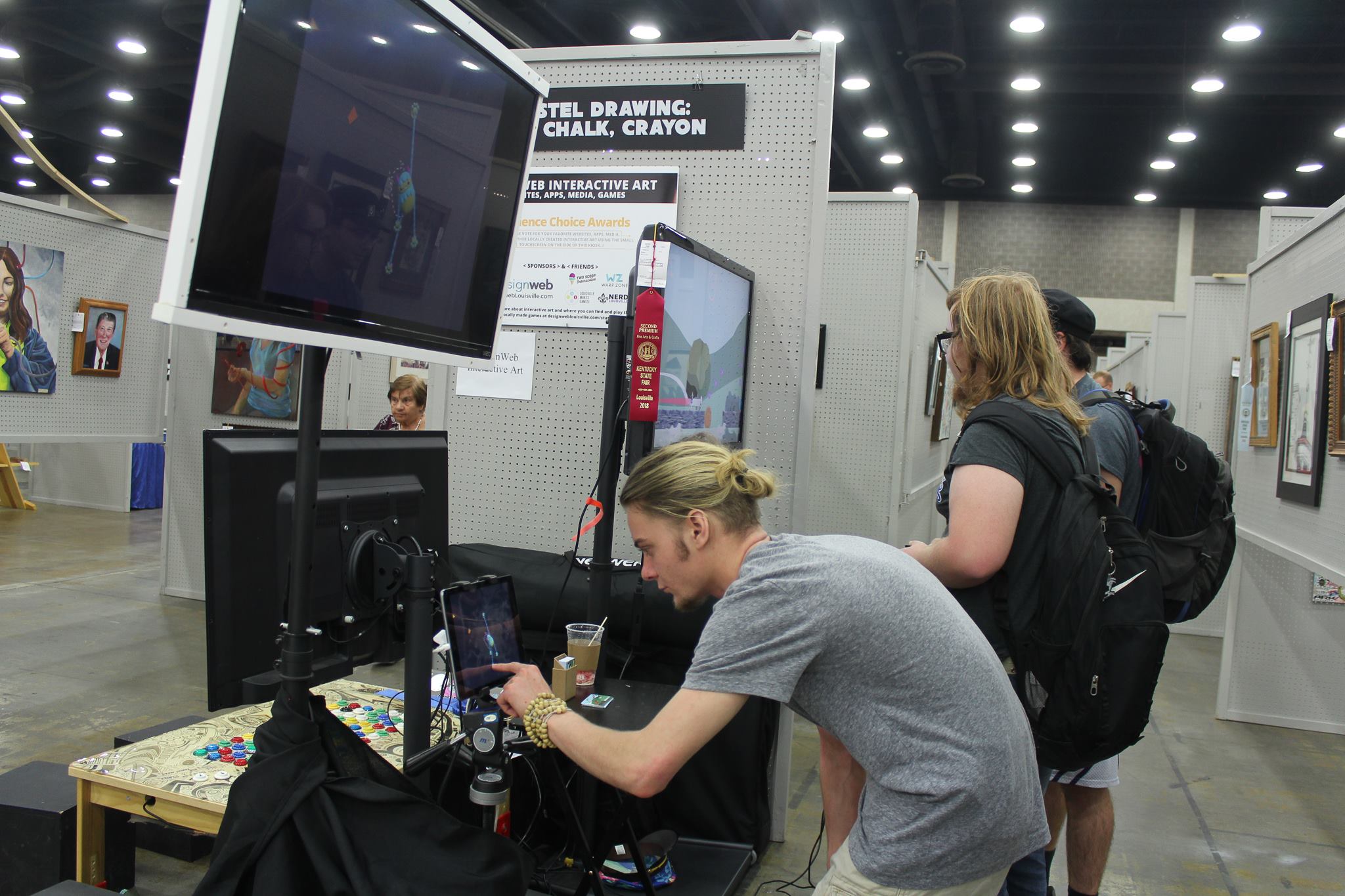 A young student sitting at a desk programming a game.
