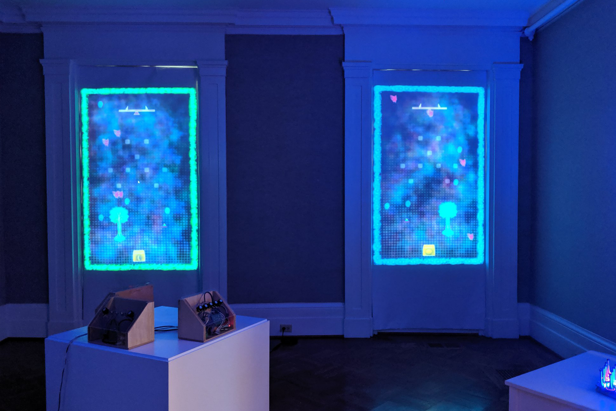 A white claw machine base full of multi-colored ping pong balls.